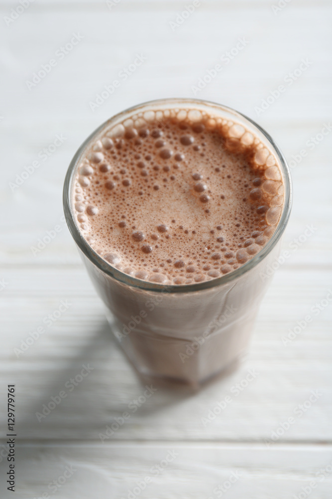 Delicious milkshake on wooden background
