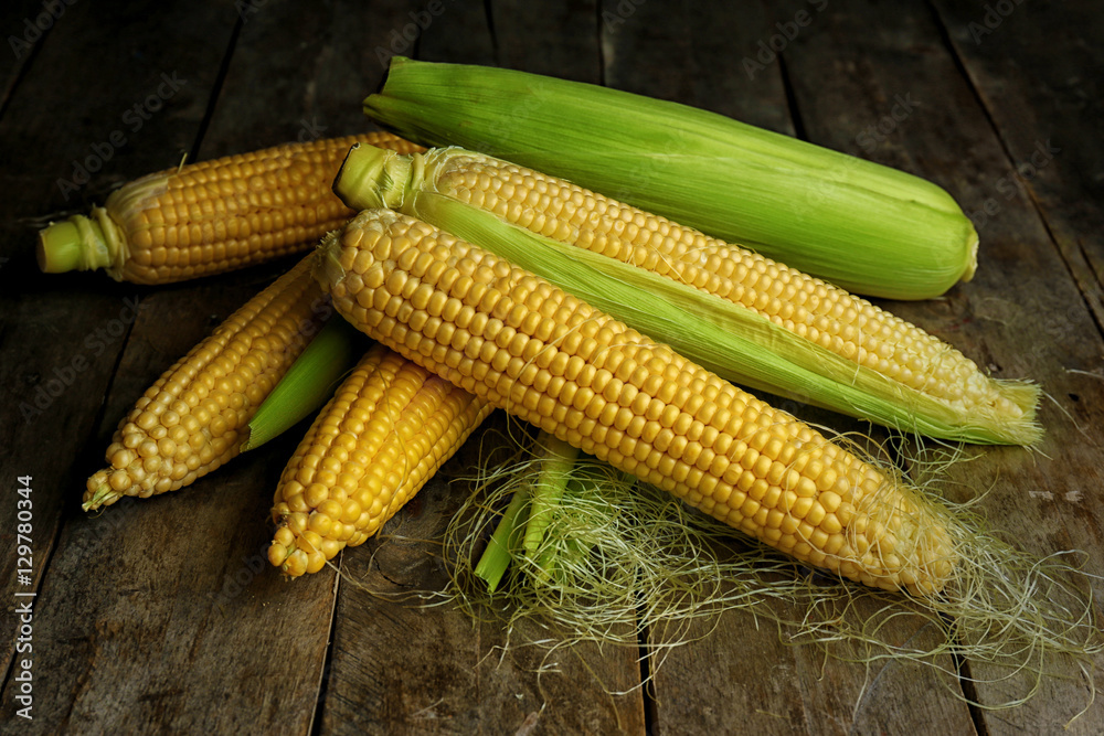 Ripe corns on wooden background