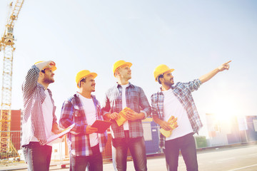 Canvas Print - group of smiling builders with tablet pc outdoors