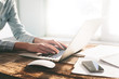 © 4Max - Woman working on a laptop and tablet pc indoor on a wooden stand