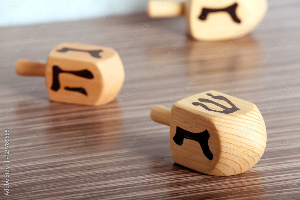 Dreidel for Hanukkah on wooden table, close up