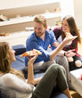 Group of friends eating pizza together at home