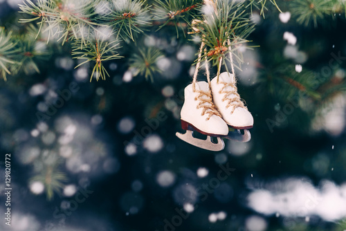 Closeup Christmas Tree Decoration Small Ice Skates On The Snowfall
