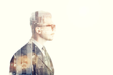 Wall Mural - Businessman with glasses side view and brown city