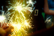 © ifeelstock - Sparkler in hands on a party - great celebration of Christmas, New Year, birthday, easter wedding and other important anniversaries