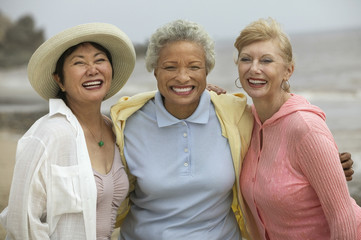 Wall Mural - Portrait of cheerful female friends enjoying vacation at beach