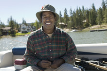 Portrait Of An African American Man Enjoys A Day Of Fishing On A Sunny Day