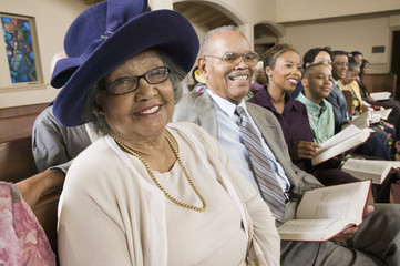 senior woman in sunday best among congregation at church portrait