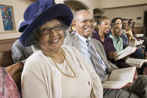 Fotomural Senior Woman in Sunday Best among congregation at Church portrait