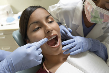 Young woman having medical procedure at dentist's clinic