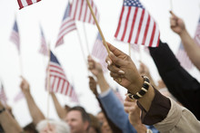 Close Up Of Hand Raising American Flag