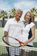 © moodboard - Portrait of happy senior couple in sportswear at tennis court