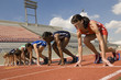 © moodboard - Group of multiethnic female athletes getting ready to start the race