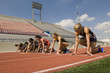 © MDBPIXS - Group of runners preparing for race at starting blocks