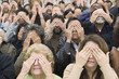 © moodboard - High angle view of people covering eyes with hands