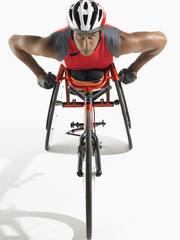 Portrait of a confident paraplegic cycler against white background