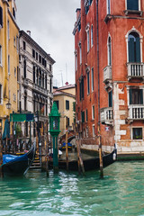 Wall Mural - mooring of gondolas near houses in Venice in rain