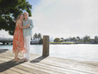 Full length portrait of a middle aged couple embracing on pier