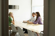 © moodboard - Three multiethnic office workers in conference room