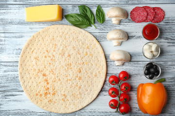 Poster - Raw pizza ingredients on wooden background, top view