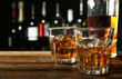© Africa Studio - Glasses of whisky on wooden bar closeup
