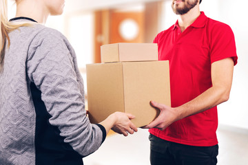 Wall Mural - woman accepting a delivery of boxes from delivery service courier