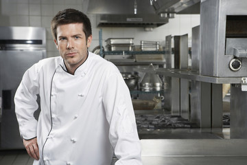 Wall Mural - Portrait of a confident male chef standing in the kitchen