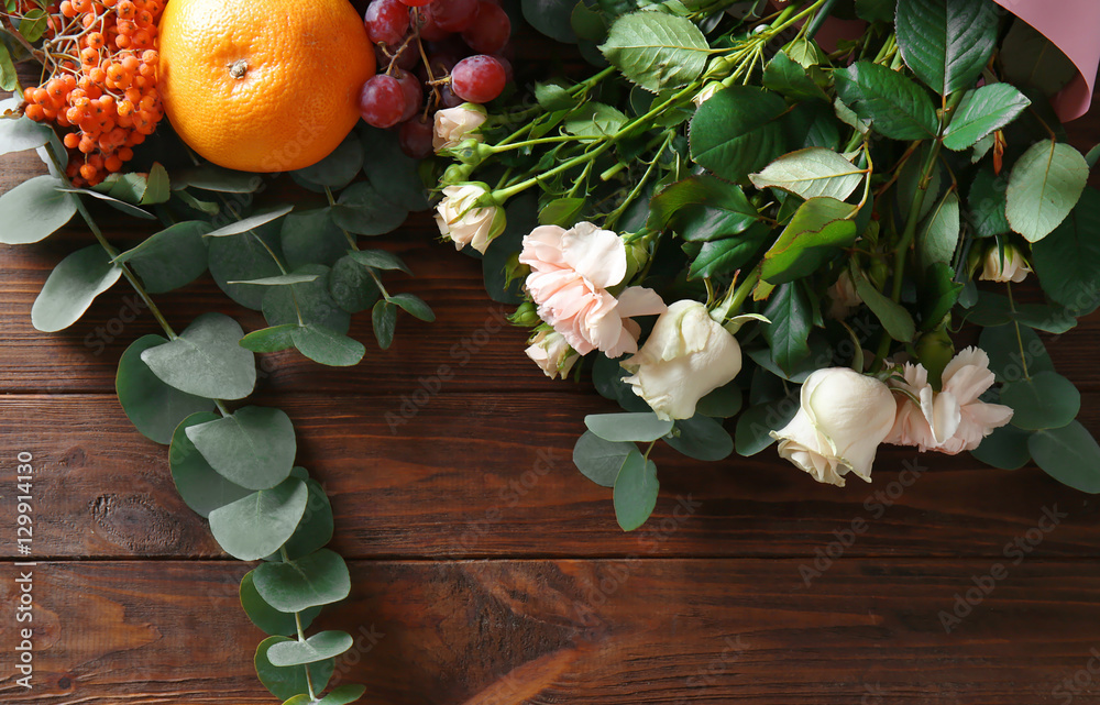 Flowers and fruits for composition on wooden background