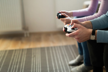 Beautiful couple playing video games on console