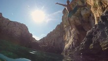 SLOW MOTION CLOSEUP: Happy Man Jumping With Hands Raised On Fun Summer Vacation
