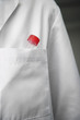 Extreme closeup of test tube in lab coat pocket