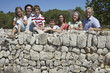 © MDBPIXS - Portrait of three generation family against stone wall outdoors