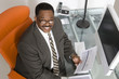 © moodboard - Top view portrait of a smiling African American businessman at his desk