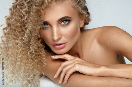 Fotografie, Obraz Beautiful Woman Model With Blonde Curly Hair And Soft Skin