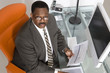 © MDBPIXS - Top view portrait of an African American businessman at his desk