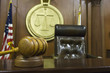 Closeup of gavel and wooden block on table with judge's chair in courtroom