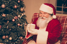 Portrait Of Aged Smiling Santa Resting With Cup Of Hot Tea