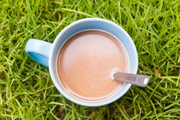 Hot coffee on grass