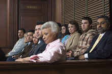 Diverse Group Of Jurors Sitting In Jury Box Of A Courtroom