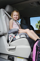 Little girl riding in the booster seat