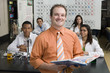 © MDBPIXS - Portrait of a happy professor holding textbook with students in science class
