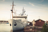 Fototapeta Psy - Old white ship moored in port of Kotka