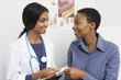 © MDBPIXS - Happy female doctor giving prescription to patient in the clinic