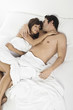 © MDBPIXS - Elevated view of a young couple lying in bed