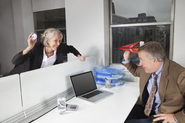 Side view of playful business colleagues in office