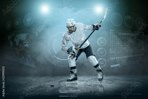Fototapeta na szkło Ice hockey player on the ice around modern light