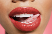 Cropped Image Of Woman Licking Red Lipstick