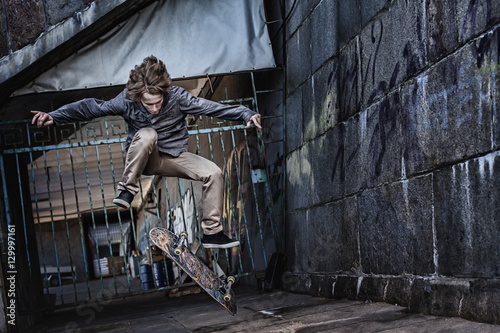 Fotografie, Obraz Jumping skateboarder on urban background
