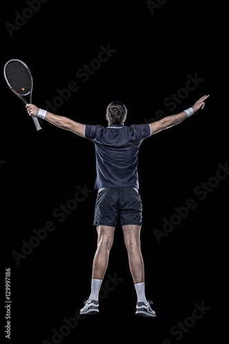 Tennis player with hands up isolated on black Poster