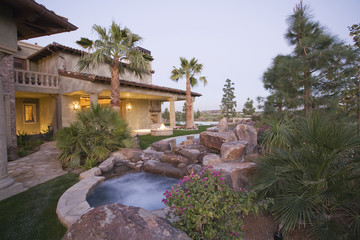 View of an outdoor Jacuzzi and modern house exterior against clear sky